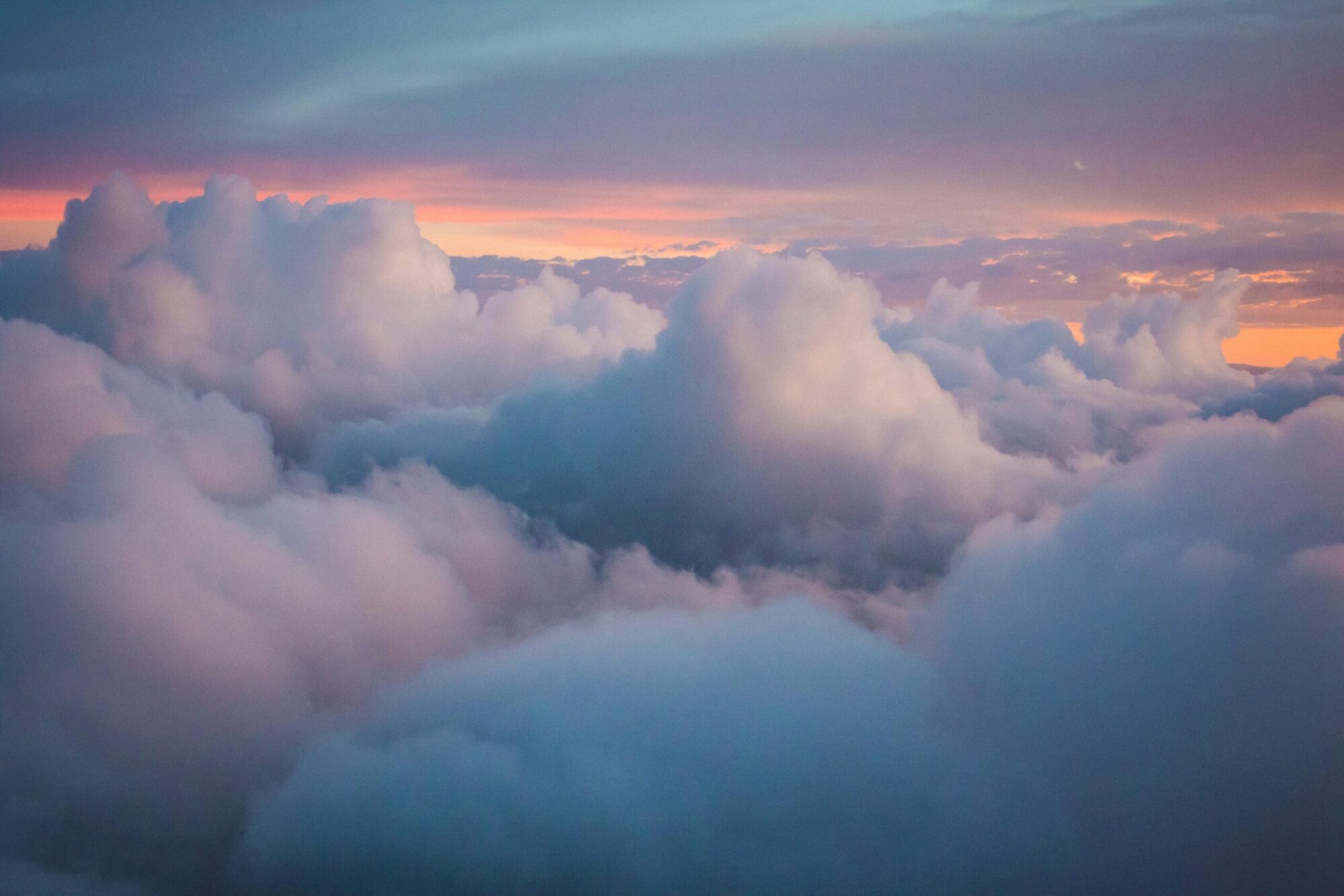 clouds in the sky with purple, cyan and sunset hues.
